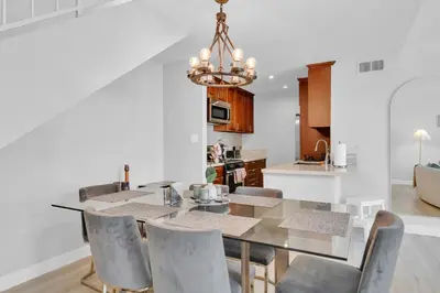 a dining room with a table and chairs at High Ceilings 3BR with Loft-2 Baths Pool & Jacuzzi in Tarzana