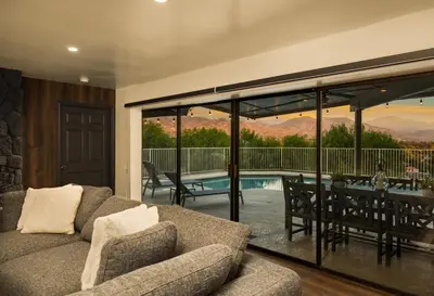 a living room with a couch and a table and a pool at Off Grid Mountaintop Paradise Pool Spa and Games in San Bernardino