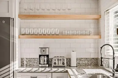 a kitchen with a sink and a counter top at 5BR Fun Haven Pool Mini Golf Movie Game room in Riverside