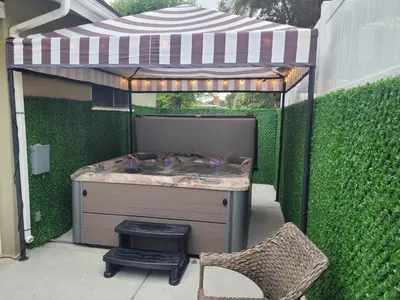 a hot tub in a gazebo with a chair at Extremely Chill 3 Bedroom Home in Long Beach