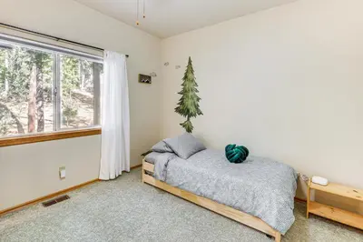 a bedroom with a bed and a window at Swim, Hike, Ski and Unwind Lake Arrowhead Retreat! in Lake Arrowhead