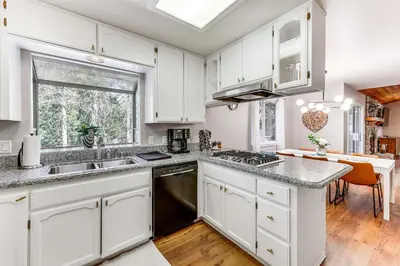 a kitchen with white cabinets and a counter top at Swim, Hike, Ski and Unwind Lake Arrowhead Retreat! in Lake Arrowhead
