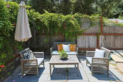a patio with a table and chairs and an umbrella at The Topanga Bungalow by Colby & Conrad in Topanga