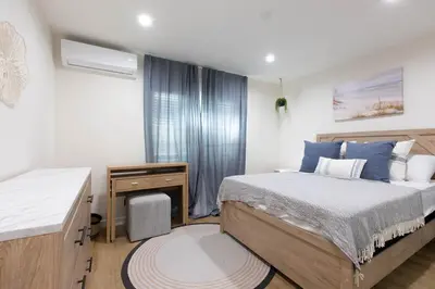 a bedroom with a bed and a dresser and a desk at Stylish Long Beach Retreat Walk to Beach Bars in Long Beach