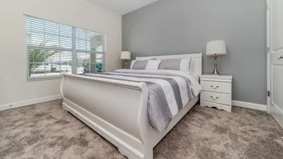a white bedroom with a large bed and a window at LBL4837 in Los Angeles