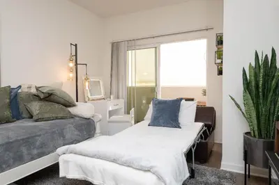 a living room with a bed and a window at Hollywood Apartment Near Walk of Fame in Los Angeles