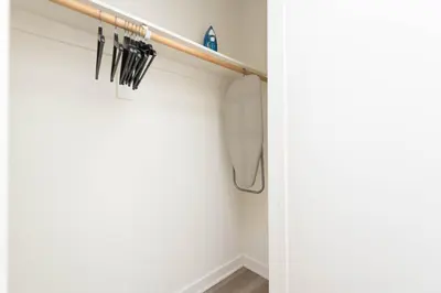 a shelf with umbrellas hanging on a wall at Hollywood Apartment Near Walk of Fame in Los Angeles