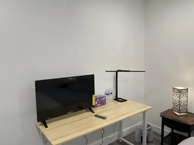 a flat screen tv sitting on top of a table at \u4fbf\u6377\u5b9c\u5c45\u7684\u72ec\u7acb\u623f\u5b50 in Baldwin Park