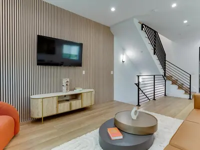 a living room with a tv on a wall at Modern Luxe Retreat Four-Bedroom in Los Angeles