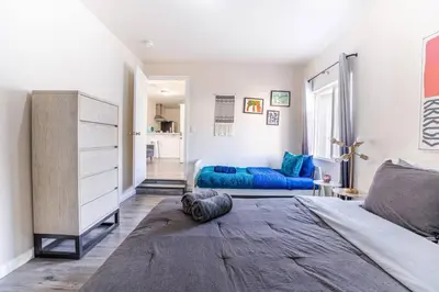 a bedroom with a bed and a blue couch at Comfy Home Near Sofi Stadium in Los Angeles