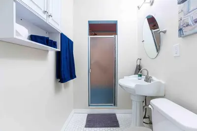 a white bathroom with a shower and a sink at Comfy Home Near Sofi Stadium in Los Angeles