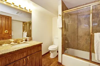 a bathroom with a toilet and a sink and a shower at The Birdhouse at Big Bear Lake- Lakeview Family Retreat in Big Bear Lake