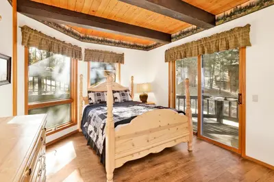 a bedroom with a bed and large windows at The Birdhouse at Big Bear Lake- Lakeview Family Retreat in Big Bear Lake