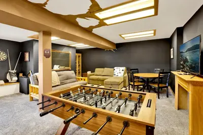 a living room with a large foosball table at The Birdhouse at Big Bear Lake- Lakeview Family Retreat in Big Bear Lake