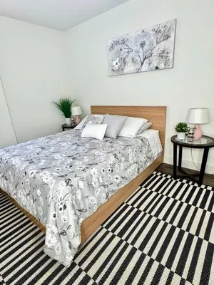 a bedroom with a bed and a rug at Beautiful 2bd 2bth apartment in Santa Monica in Los Angeles