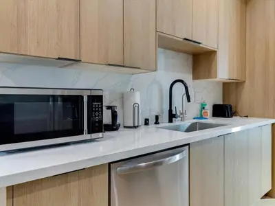 a kitchen with a microwave and a sink at Modern Luxe Retreat Two-Bedroom in Los Angeles
