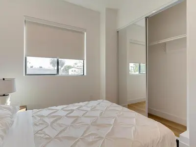 a white bedroom with a large bed and a window at Modern Luxe Retreat Two-Bedroom in Los Angeles