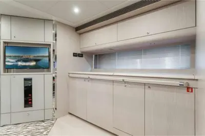 a kitchen with white cabinets and a flat screen tv at Riva Virtus 65 Yacht Trip w Captain Overnight Stay 2812 in Los Angeles