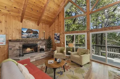 a living room with a fireplace in a house at Cozy Escape- Walking Distance to Village! in Lake Arrowhead