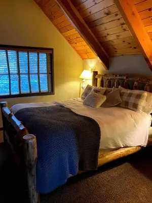 a bedroom with a large bed with a window at Cozy Escape- Walking Distance to Village! in Lake Arrowhead