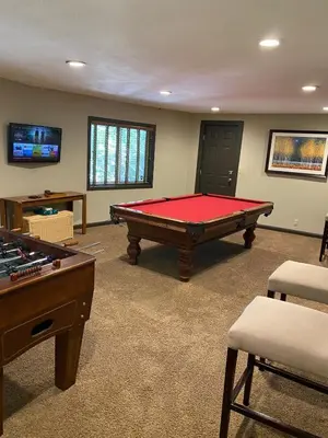 a room with a pool table and a tv at Cozy Escape- Walking Distance to Village! in Lake Arrowhead