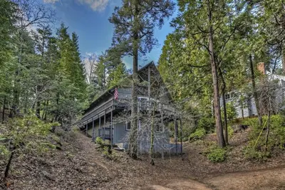 an image of a house in the woods at Cozy Escape- Walking Distance to Village! in Lake Arrowhead