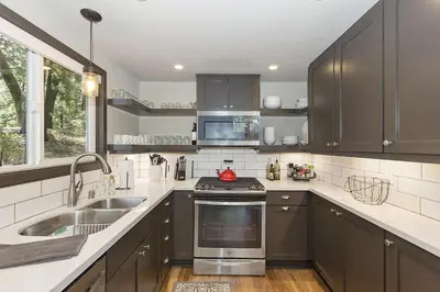 a kitchen with a sink and a stove top oven at Cozy Escape- Walking Distance to Village! in Lake Arrowhead