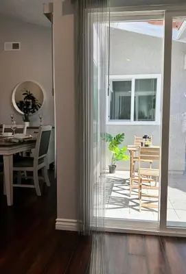 a dining room with a table and a sliding glass door at Cactus Casino with game room next to Yaamava Casino in Highland
