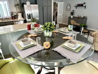 a glass table with plates and glasses on top of it at Cactus Casino with game room next to Yaamava Casino in Highland
