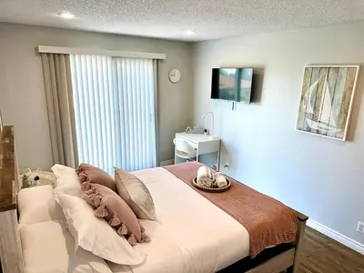 a bedroom with a large bed with a tray on it at Cactus Casino with game room next to Yaamava Casino in Highland