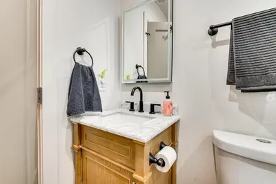 a bathroom with a sink and a mirror at 1 Mi to Rose Bowl! Updated Home with Furnished Deck in Pasadena