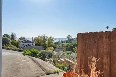 a wooden fence in front of a house at Whitney Oceanview Studio in Summerland