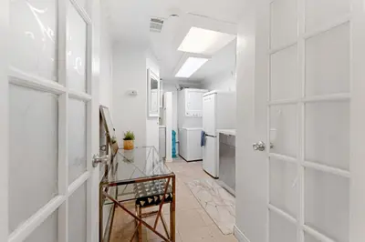a hallway with a glass table and a door at The Hidden Hideaway in Summerland