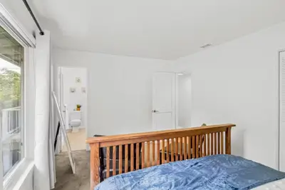 a bedroom with a bed with a wooden head board at Summerland Beach Oasis- Pet Friendly in Summerland