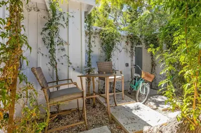 a patio with chairs and a table and a bike at Jennifers Room - Pet Friendly in Summerland