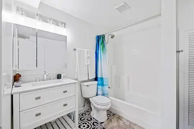 a white bathroom with a toilet and a sink at The Grand Escape - Casita Sonrisa in Summerland