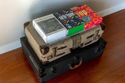 two books sitting on top of an old suitcase at On Sunset Blvd - 5 star retreat in Los Angeles