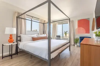 a bedroom with a canopy bed and a desk at 3BR Townhouse in Prime Manhattan Beach Location in Manhattan Beach