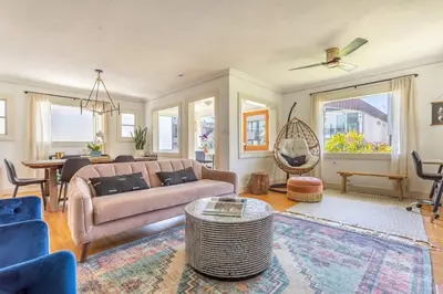 a living room with a couch and a table at Charming 1920s Hermosa Bungalow Steps from The Strand in Hermosa Beach