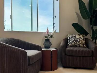 two chairs and a table in a living room at Hollywood hill stunning view cozy private room in Los Angeles