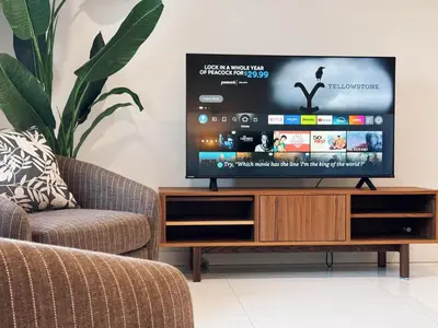 a living room with a flat screen tv on a wooden entertainment center at Hollywood hill stunning view cozy private room in Los Angeles