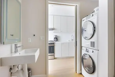 a bathroom with a sink and a washing machine at Blueground Downtown elevator nr parks LAX-1245 in Los Angeles