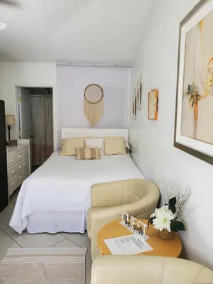 a bedroom with a bed and a couch and a table at Studio in Southbay close to the beach SoFi stadium LAX in Lawndale