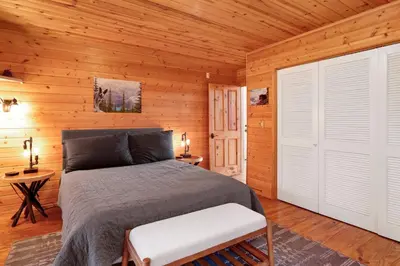 a bedroom with a bed in a wooden cabin at High-Top Lakeview Chateau #2520 in Fawnskin