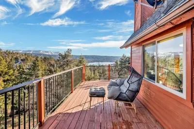 a balcony with a chair on a wooden deck at High-Top Lakeview Chateau #2520 in Fawnskin