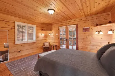 a bedroom with a bed in a wooden cabin at High-Top Lakeview Chateau #2520 in Fawnskin