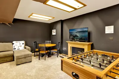 a living room with a table and a large game board at The Birdhouse #2529 in Big Bear Lake