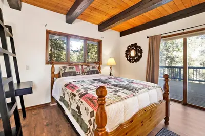 a bedroom with a wooden bed with a wooden ceiling at The Birdhouse #2529 in Big Bear Lake