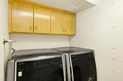 a kitchen with a microwave and wooden cabinets at The Birdhouse #2529 in Big Bear Lake