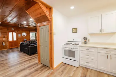a kitchen with white appliances and a living room at Kelley's Kabin #290 in Big Bear Lake
